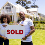Couple with sold sign