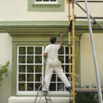 Man Painting House