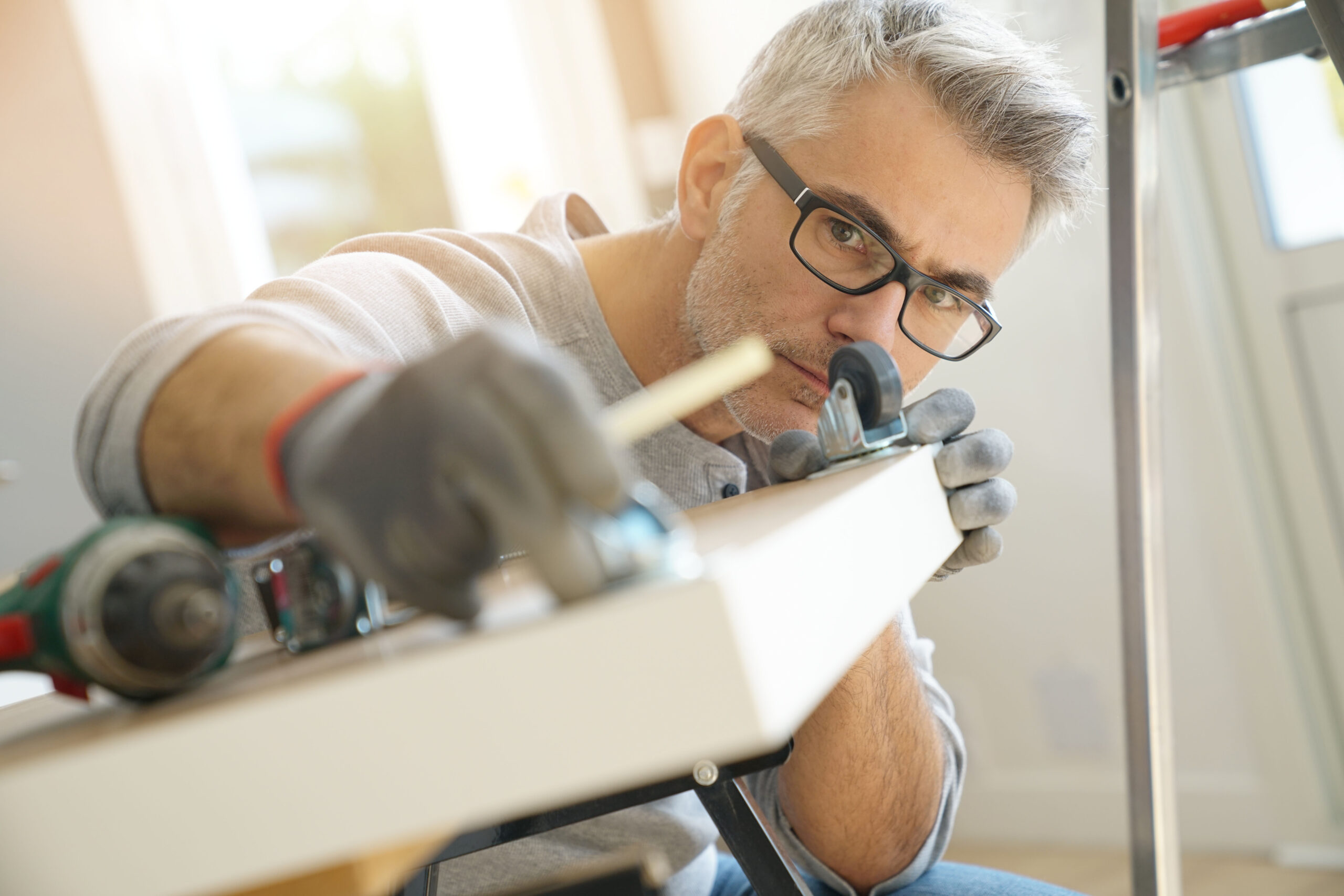 Man at home assembling DIY furniture